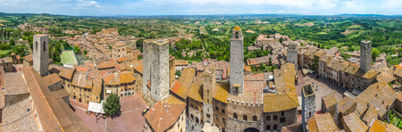 Aerial wide-angle view of the historic town of San Gimignano with tuscan countryside on a sunny day, Tuscany, Italyの写真素材