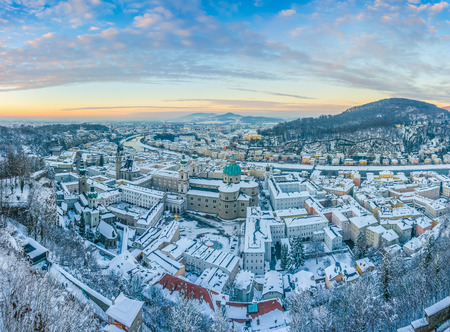 Beautiful panoramic view of the historic city of Salzburg with Salzach river from top of Festung Hohensalzburg in winter at sunset, Salzburger Land, Austriaの写真素材