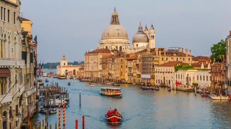 Romantic view of famous Canal Grande and Basilica di Santa Maria della Salute at sunset in Venice, Italyの写真素材