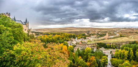 Panoramic view of Segovia Castle Alcazar of Segovia in the historic city of Segovia with summer landscape and dramatic thunderclouds, Castilla y Leon, Spainの写真素材