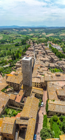Aerial wide-angle view of the historic town of San Gimignano with Tuscan countryside on a sunny day, Tuscany, Italyの写真素材