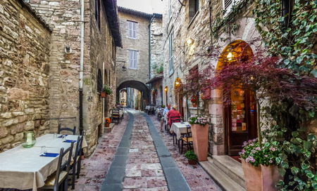 Romantic dinner place in a beautiful alley in the ancient town of Assisi, Umbria, Italy Romantic dinner place in a beautiful alley in the ancient town of Assisi, Umbria, Italy