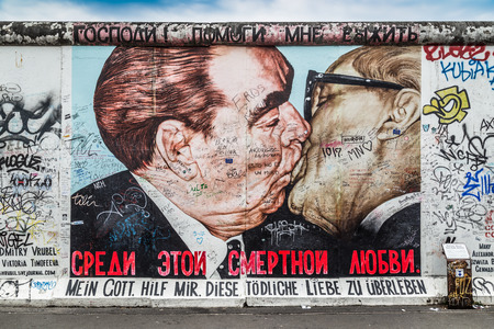 BERLIN, GERMANY - JULY 12: Street art graffiti painting 'The Kiss' by Dmitri Vrubel at famous East Side Gallery, the longest preserved section of the Berlin wall, on July 12, 2015 in Berlin, Germany.のeditorial素材
