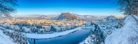 Beautiful panoramic view of Salzburg skyline with Festung Hohensalzburg and river Salzach in winter, Salzburger Land, Austriaの写真素材