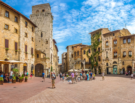 Panoramic view of famous Piazza della Cisterna in the historic town of  San Gimignano on a sunny day, Tuscany, Italyの写真素材
