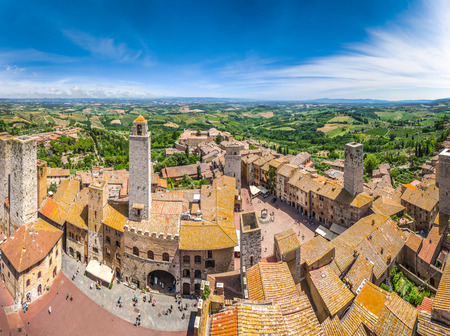 Aerial wide-angle view of the historic town of San Gimignano with tuscan countryside on a sunny day, Tuscany, Italyの写真素材