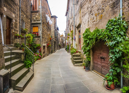Beautiful view of old traditional houses and idyllic alleyway in the historic town of Vitorchiano, province of Viterbo, Lazio, Italyの写真素材