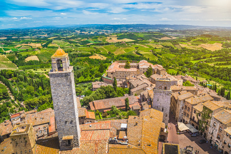 Aerial wide-angle view of the historic town of San Gimignano with Tuscan countryside on a sunny day, Tuscany, Italyの写真素材