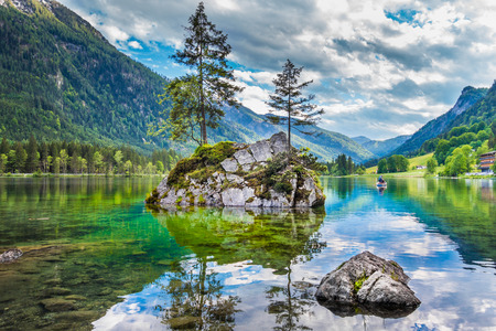 Beautiful scene of trees on a rock island in idyllic scenery at charming Lake Hintersee, Nationalpark Berchtesgadener Land, Upper Bavaria, Germanyの写真素材