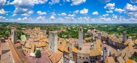 Aerial wide-angle view of the historic town of San Gimignano with tuscan countryside on a sunny day, Tuscany, Italyの写真素材