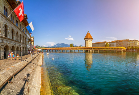 Famous Chapel Bridge in the historic city center of Lucerne, the city's symbol and one of Switzerland's main tourist attractions and views on a sunny day in summer, Canton of Lucerne, Switzerlandの写真素材