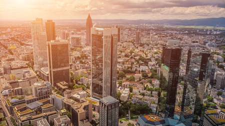 Beautiful panoramic view of modern skyscrapers in famous city center of Frankfurt am Main in golden evening light at sunset in summer, Hessen, Germanyの写真素材