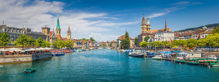 Panoramic view of historic Zurich city center with famous Fraumunster, Grossmunster and St. Peter and river Limmat at Lake Zurich on a sunny day with clouds in summer, Canton of Zurich, Switzerland