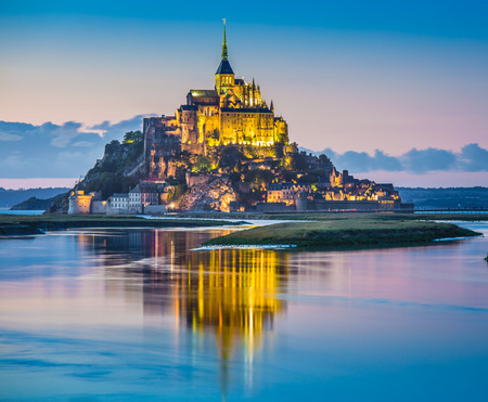 Panoramic view of famous Le Mont Saint-Michel tidal island in beautiful twilight during blue hour at dusk, Normandy, northern Franceの写真素材