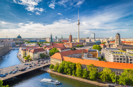 Aerial view of Berlin skyline with famous TV tower and Spree river on a beautiful day with blue sky and clouds in summer, Germanyの写真素材