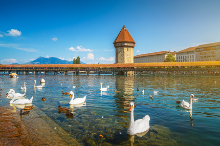 Famous Chapel Bridge in the historic city center of Lucerne, the city's symbol and one of Switzerland's main tourist attractions and views on a sunny day in summer, Canton of Lucerne, Switzerlandの写真素材