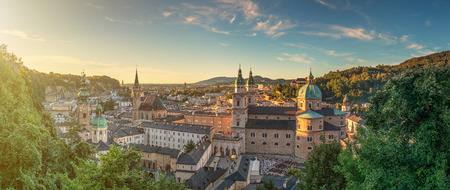 Panoramic view of the historic city of Salzburg with beautiful Salzach river from famous Hohensalzburg Fortress in golden evening light at sunset in summer, Salzburger Land, Austriaの写真素材