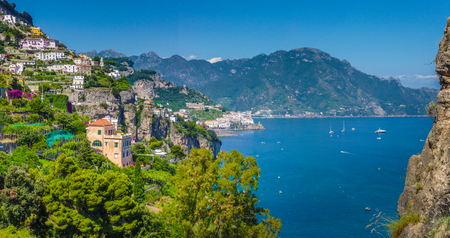 Panoramic picture-postcard view of the beautiful town of Amalfi at famous Amalfi Coast with Gulf of Salerno on a sunny day with blue sky in summer, Campania, Italyの写真素材