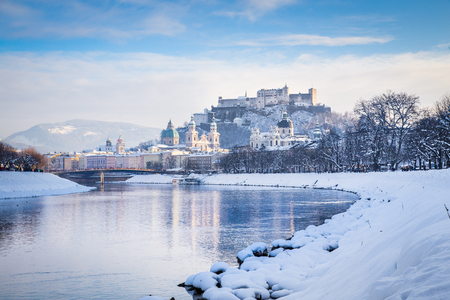 Classic view of the historic city of Salzburg with Salzach river on a beautiful cold sunny day with blue sky and clouds in winter, Salzburger Land, Austriaの写真素材