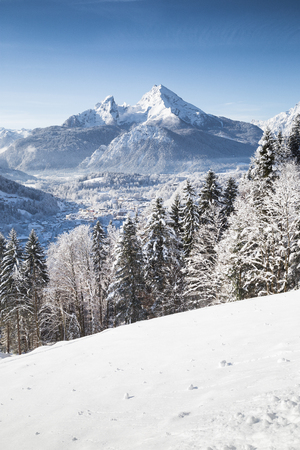 Vertical view of beautiful winter wonderland scenery with the historic town of Berchtesgaden and scenic Watzmann mountain in the Alps, Bavaria, Germanyの写真素材
