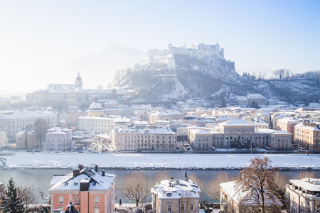 Classic view of the historic city of Salzburg with famous Hohensalzburg Fortress and Salzach river in scenic morning light at sunrise on a beautiful cold sunny day in winter, Salzburger Land, Austriaの写真素材