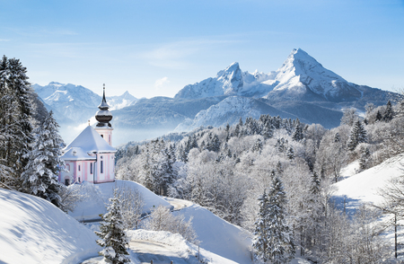 Panoramic view of beautiful winter wonderland mountain scenery in the Alps with pilgrimage church of Maria Gern and famous Watzmann summit in the background, Berchtesgadener Land, Bavaria, Germanyの写真素材