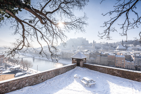 Classic view of the historic city of Salzburg with famous Hohensalzburg Fortress and Salzach river in scenic morning light at sunrise on a beautiful cold sunny day in winter, Salzburger Land, Austriaの写真素材