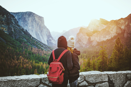 Romantic view of a young couple enjoying famous Tunnel View in beautiful golden morning light at sunrise in Yosemite Valley in summer with retro vintage style filter effect, California, USAの写真素材