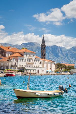 Scenic panorama view of the historic town of Perast at world famous Bay of Kotor on a beautiful sunny day with blue sky and clouds in summer, Montenegro, southern Europeの写真素材