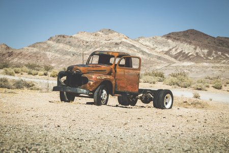 Classic view of an old rusty pickup truck car wreck in the desert on a beautiful sunny day with blue sky in summerの写真素材