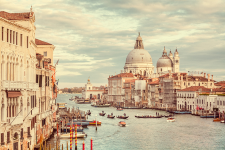 Classic panoramic view of famous Canal Grande with scenic Basilica di Santa Maria della Salute in beautiful golden eveningの写真素材