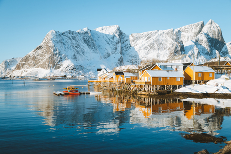 Beautiful view of scenic Lofoten Islands archipelago winter scenery with traditional yellow fisherman Rorbuer cabinsの写真素材