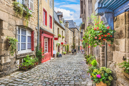 Beautiful view of scenic narrow alley with historic traditional houses and cobbled street in an old town in Europeの写真素材