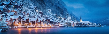Panorama view of famous Hallstatt lakeside town in the Alps in mystic twilight during blue hour at dawnの写真素材