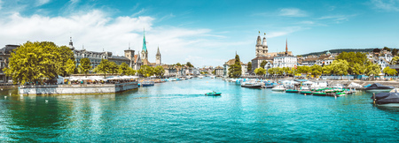 Panoramic view of Zurich city center with churches and boats on beautiful river Limmat in summer, Canton of Zurich, Switzerlandの写真素材
