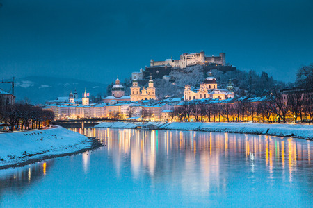 Classic view of the historic city of Salzburg with famous Festung Hohensalzburg and Salzach river illuminated in beautiful twilight during scenic Christmas time in winter, Salzburger Land, Austriaの写真素材