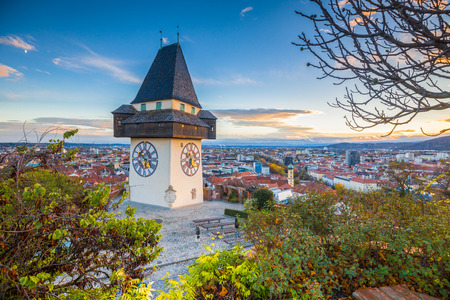 Classic panorama view of the historic city of Graz with famous Grazer Uhrturm clock tower in beautiful evening light at sunset, Styria, Austriaのeditorial素材