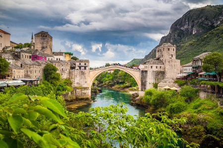 Panoramic aerial view of the historic town of Mostar with famous Old Bridge (Stari Most), a UNESCO World Heritage Site since 2005, on a rainy day with dark clouds in summer, Bosnia and Herzegovinaの写真素材
