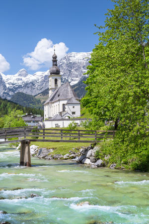 Scenic mountain landscape in the Bavarian Alps with famous Parish Church of St. Sebastian in the village of Ramsau in springtime, Nationalpark Berchtesgadener Land, Upper Bavaria, Germanyの写真素材