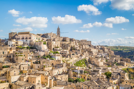 Panoramic view of the ancient town of Matera (Sassi di Matera) on a sunny day with blue sky and clouds, Basilicata, southern Italyの写真素材