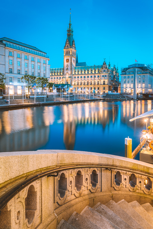 Classic twilight view of Hamburg city center with historic town hall reflecting in Binnenalster during blue hour at dusk, Germanyの写真素材