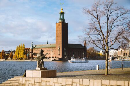 Scenic view of famous Stockholm city hall with Djurgarden ferry boat and Evert Taube statue, central Stockholm, Sweden, Scandinaviaの写真素材