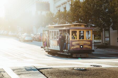 Historic Cable Car riding on famous California Street in beautiful golden evening light at sunset, San Francisco, California, USAのeditorial素材