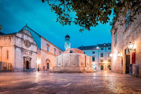 Beautiful twilight view of the historic town of Dubrovnik with famous Onofrio's fountain at dusk , Dalmatia, Croatiaの写真素材