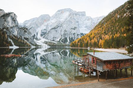 Scenic view of traditional wooden boathouse at famous Lago di Braies with Dolomites mountain peaks reflecting in lake, South Tyrol, Italy mountain peaks reflecting in lake, South Tyrol, Italyのeditorial素材