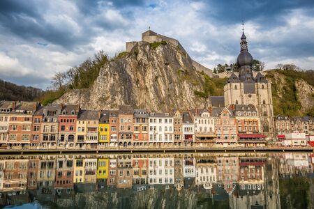Classic view of the historic town of Dinant with scenic River Meuse in beautiful golden evening light at sunset, province of Namur, Wallonia, Belgiumの写真素材