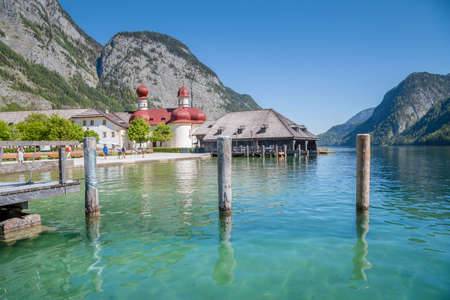Classic panoramic view of Lake Konigssee with world famous Sankt Bartholomae pilgrimage church and Watzmann mountain on a beautiful sunny day in summer, Berchtesgadener Land, Bavaria, Germanyのeditorial素材