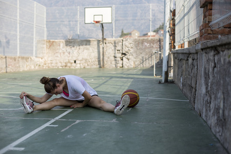 Professional female basketball player stretchingの写真素材