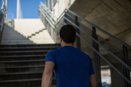 Male runner climbing up the stairs with ease