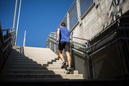 Male runner climbing up the stairs with ease